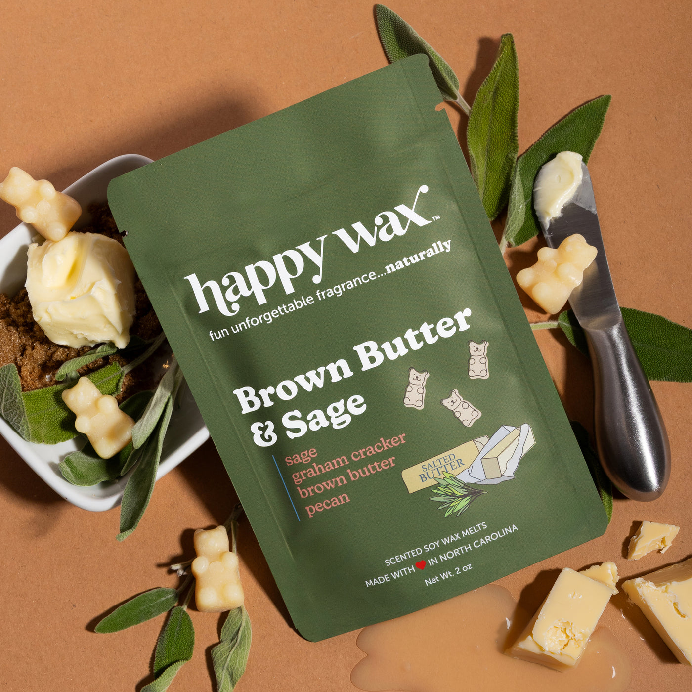 Happy Wax Brown Butter & Sage Pouch with sage leaves, butter and brown sugar on brown background