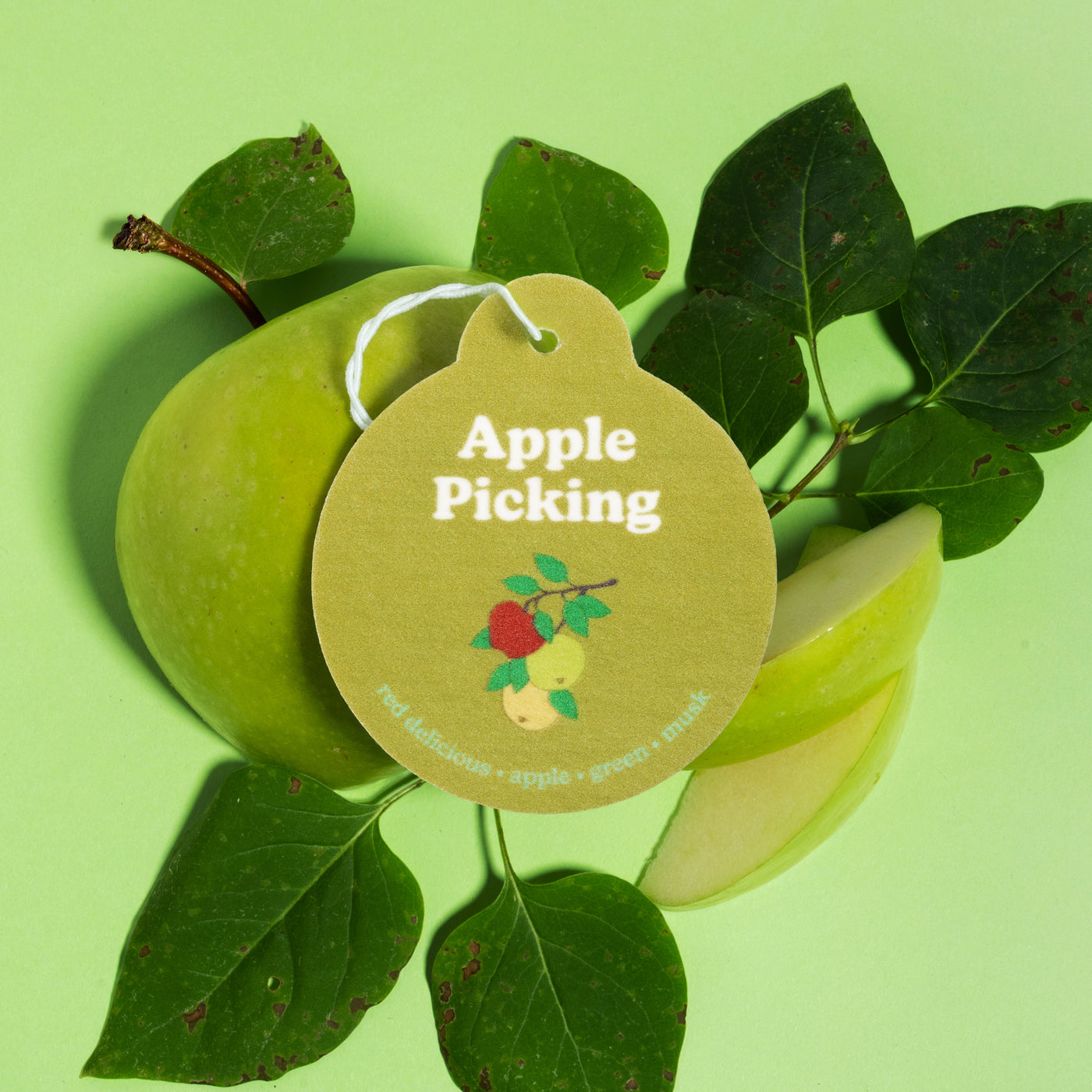 Happy Wax Apple Picking Car Charms with green apples and greenery on light green background