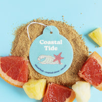 Light blue teardrop-shaped car charm with white string, featuring "Coastal Tide" text, shell, and starfish illustration on sa