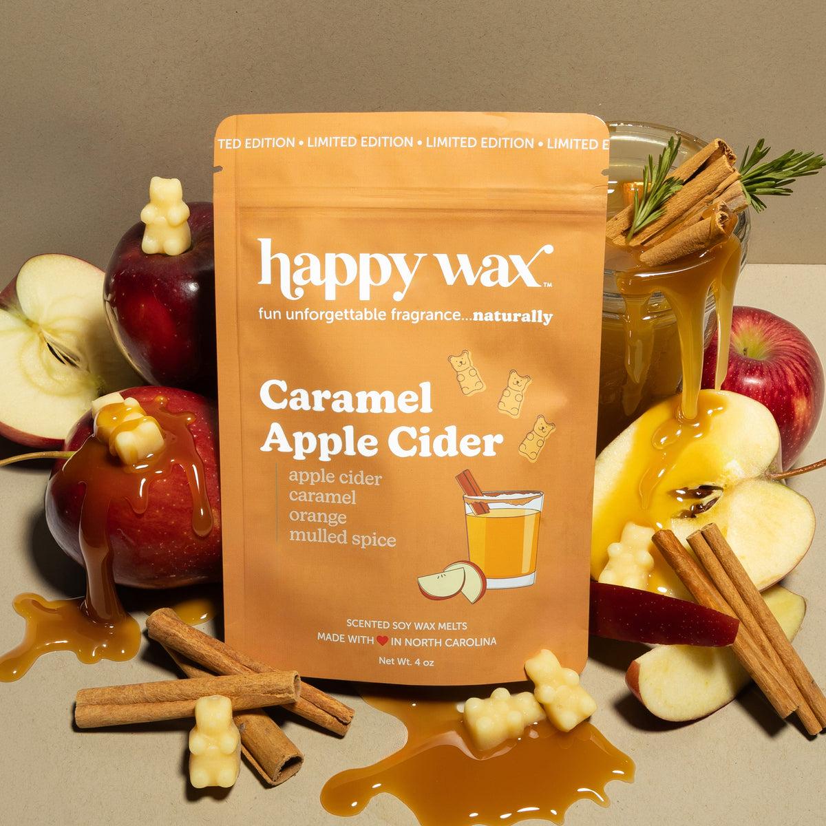 Happy Wax Caramel Apple Cider Pouch with apples, caramel, cinnamon sticks and cider on tan background