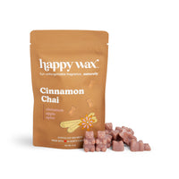 Tan pouch of Happy Wax Cinnamon Chai wax melts with mauve-colored wax cubes displayed in front.