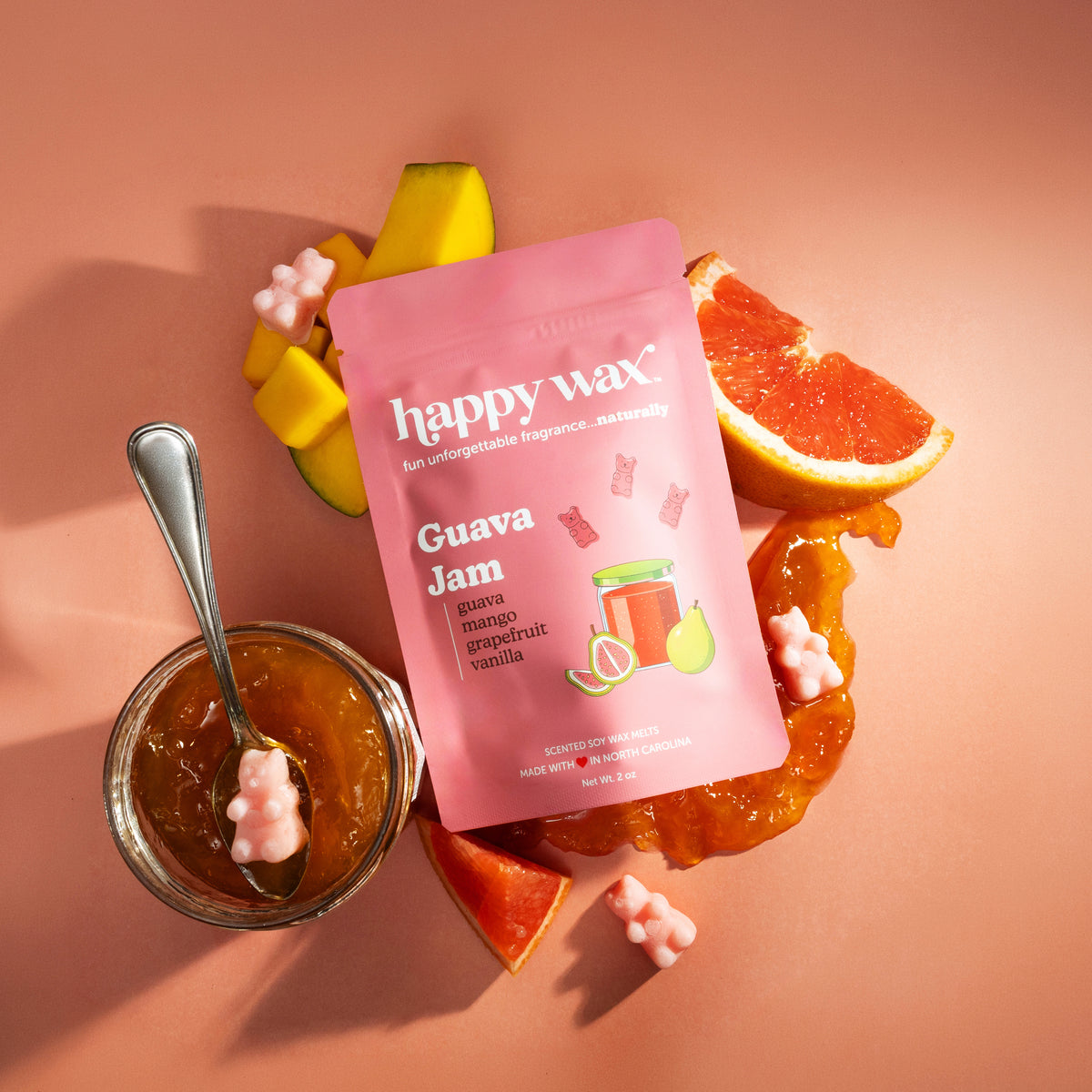 Happy Wax Guava Jam wax melts packaging with a jar of jam, spoon, and fruit on a pink background