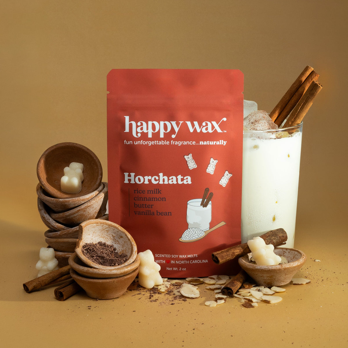 Happy Wax Horchata Wax Melts with cinnamon, terracotta bowls, and a Horchata drink tan background