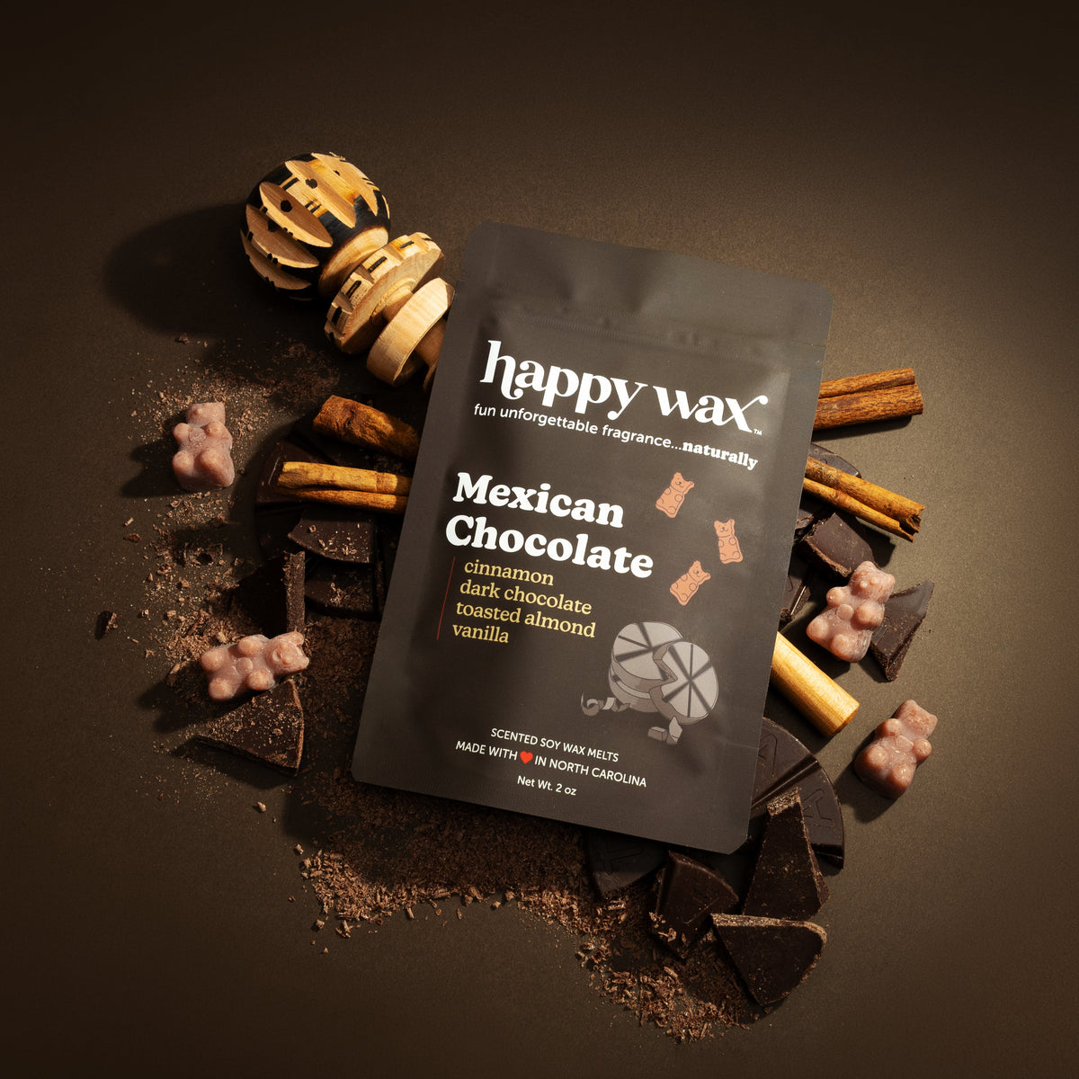 happy wax Mexican Chocolate wax melt packaging with chocolate-themed elements on a dark background