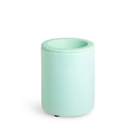 Mint green cylindrical wax warmer with wide opening and removable lid.