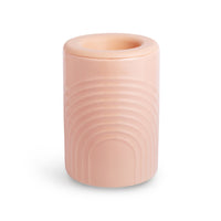 Pink cylindrical wax warmer with concentric arc design and removable top bowl.