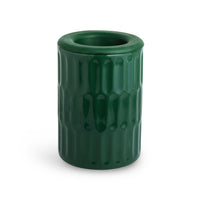 Green cylindrical wax warmer with textured vertical pattern and open top.