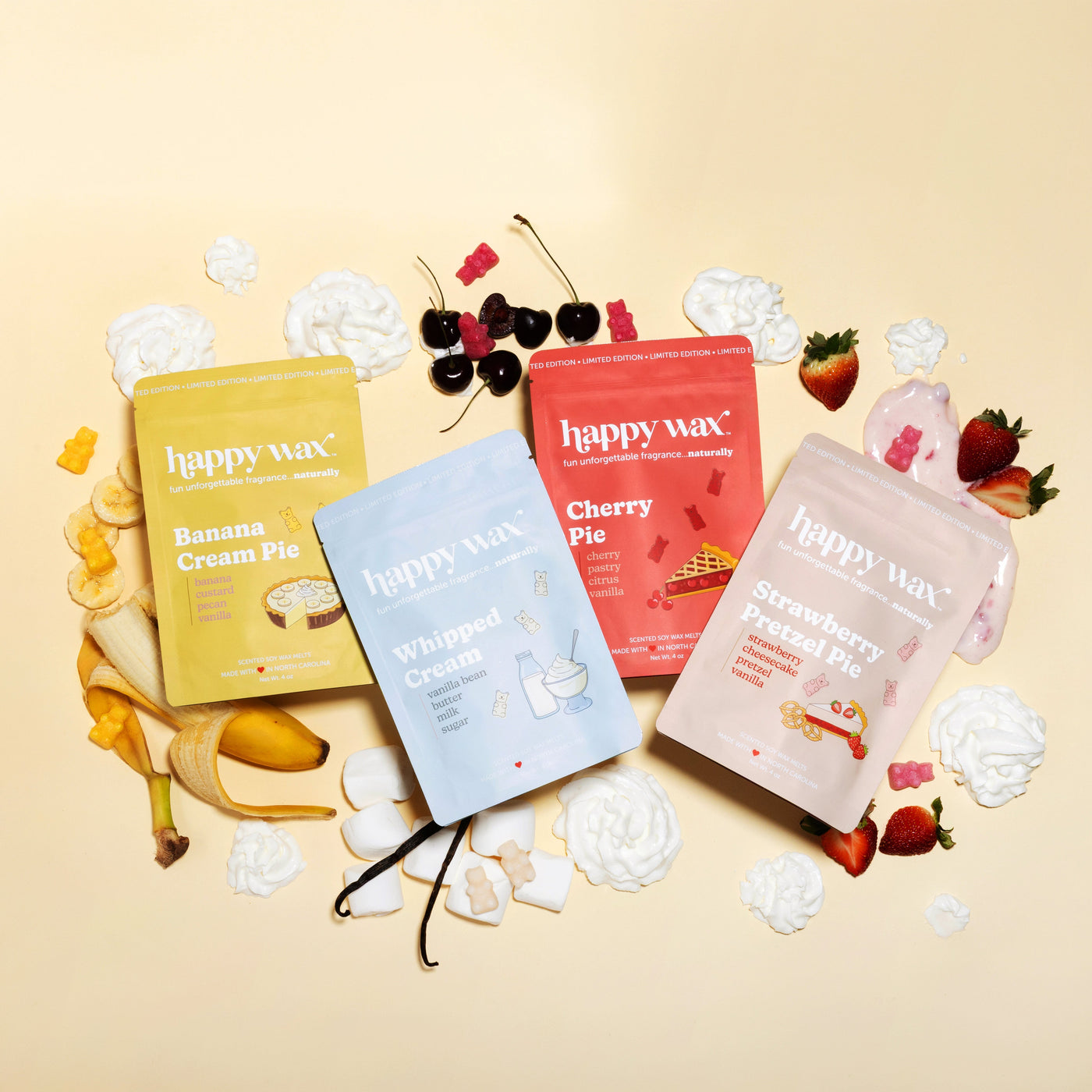 Happy Wax wax melts with fruit and dessert-themed packaging on a beige background