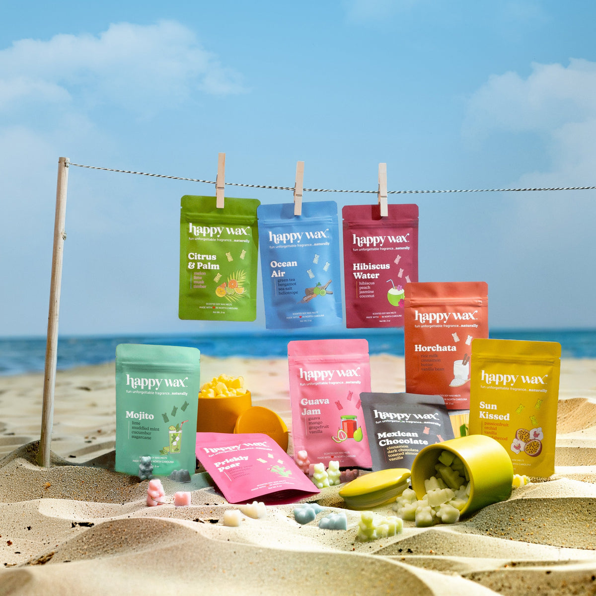 Happy Wax summer wax melts collection on a sandy beach with ocean view