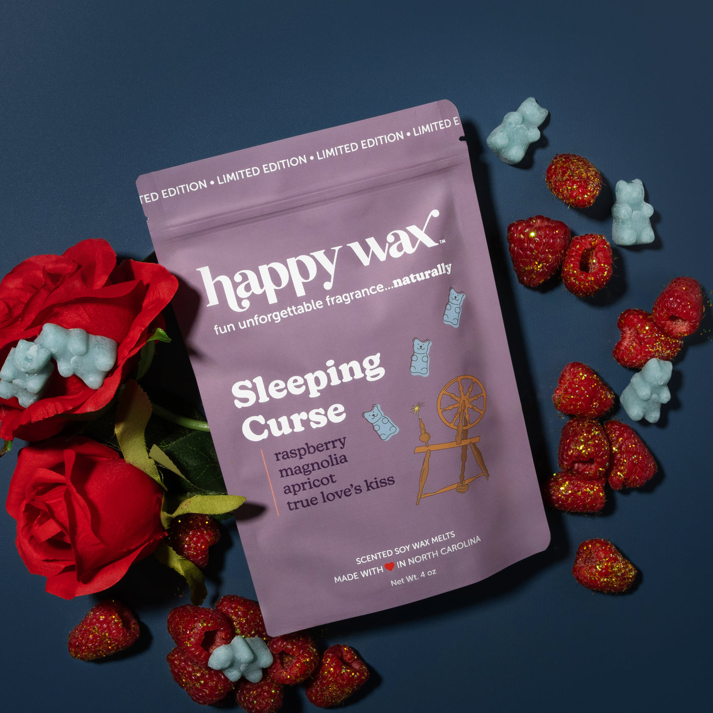 Happy Wax Sleeping Curse Pouch with red roses, raspberries and tossed in glitter on muted blue background