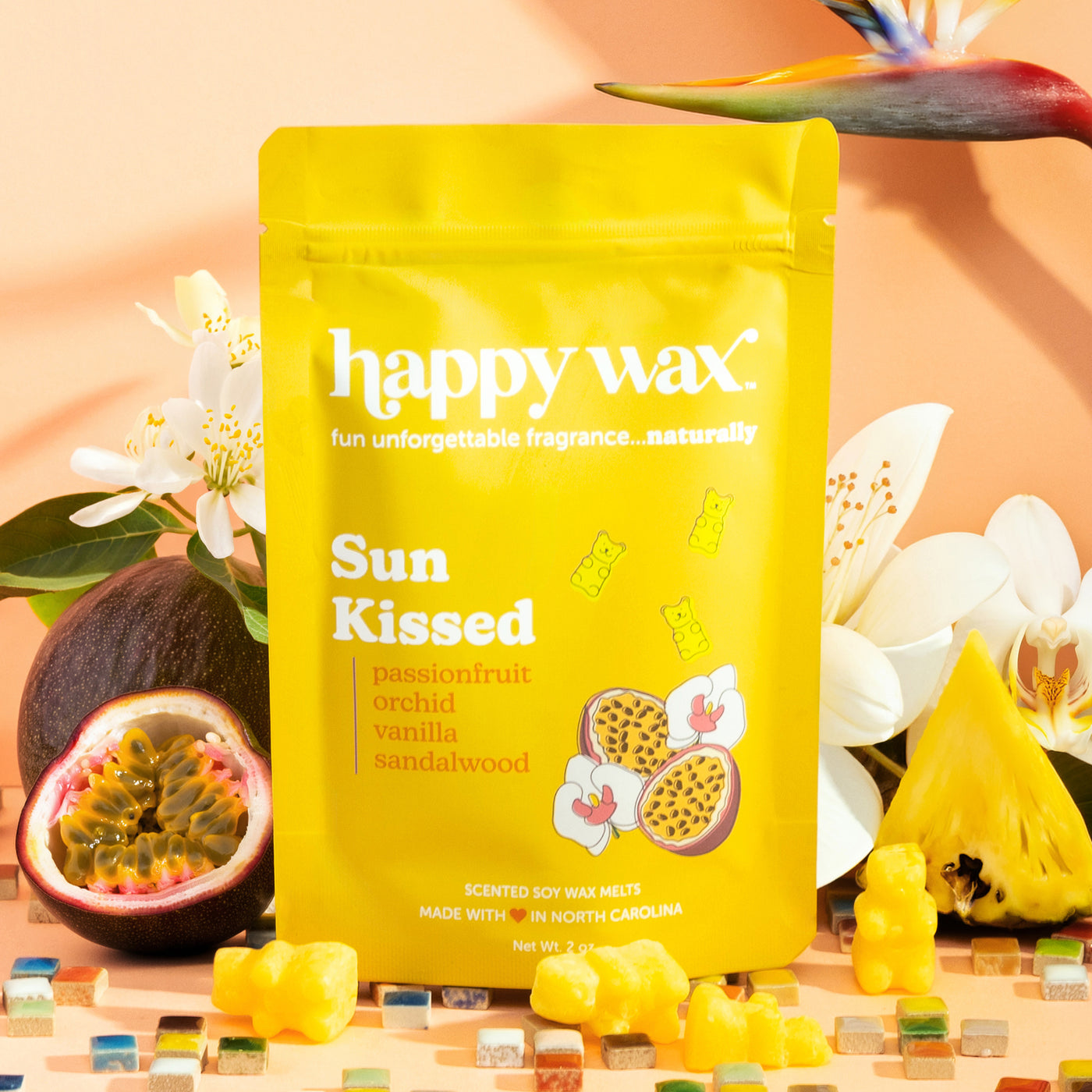 Happy Wax Sun Kissed wax melts packaging with flowers and fruit on a mosaic background