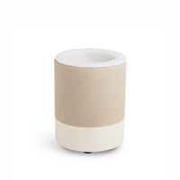 Cylindrical wax warmer with textured tan band around white ceramic body and recessed top opening.