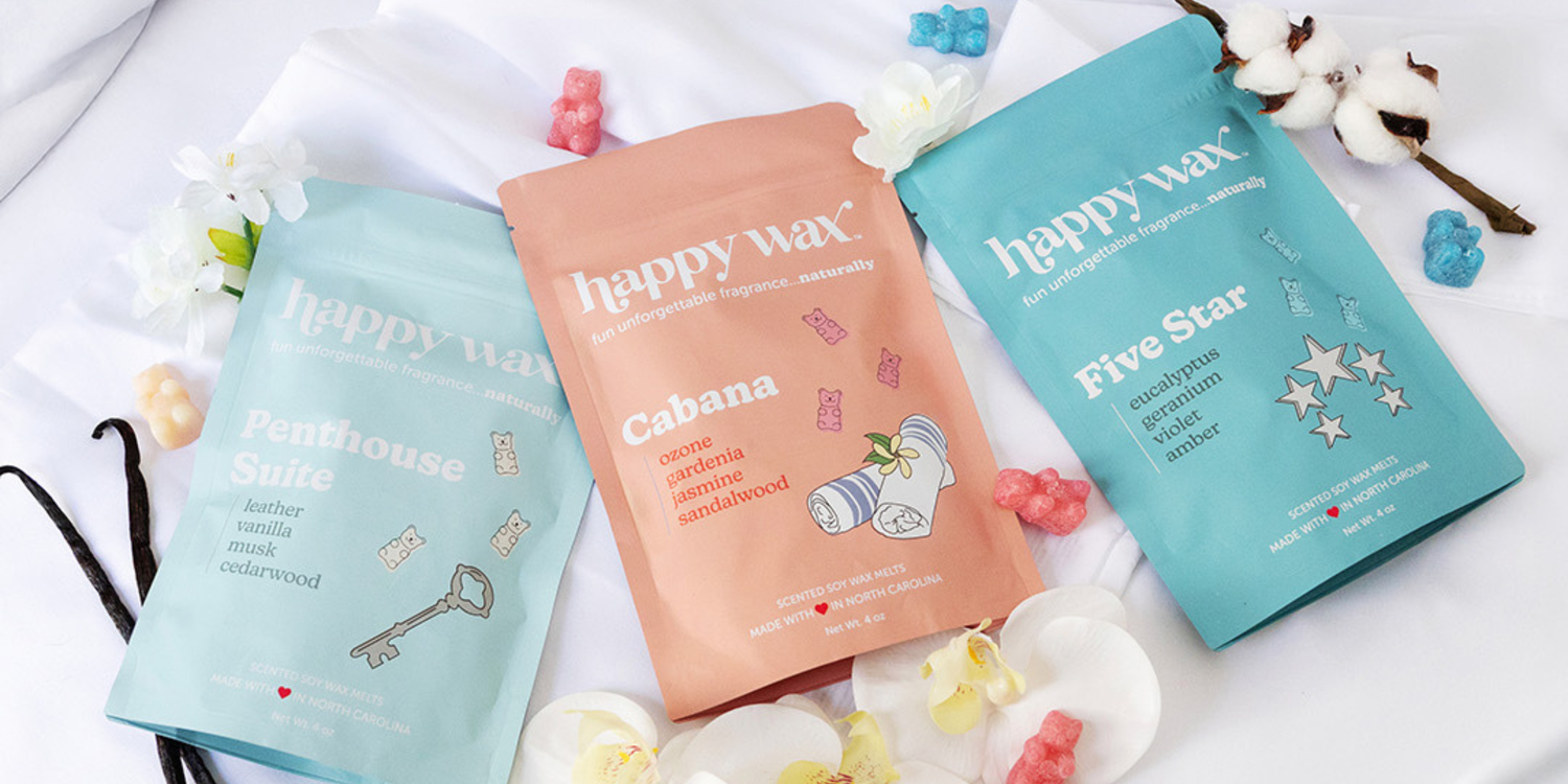 Happy Wax hotel collection wax melts on white sheets with flowers