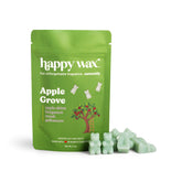 Green pouch of Happy Wax Apple Grove scented soy wax melts with pale green wax melts displayed in front.