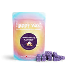 Purple wax melts next to a gradient pouch labeled "happy wax" with "Blackberry Cobbler" flavor branding.