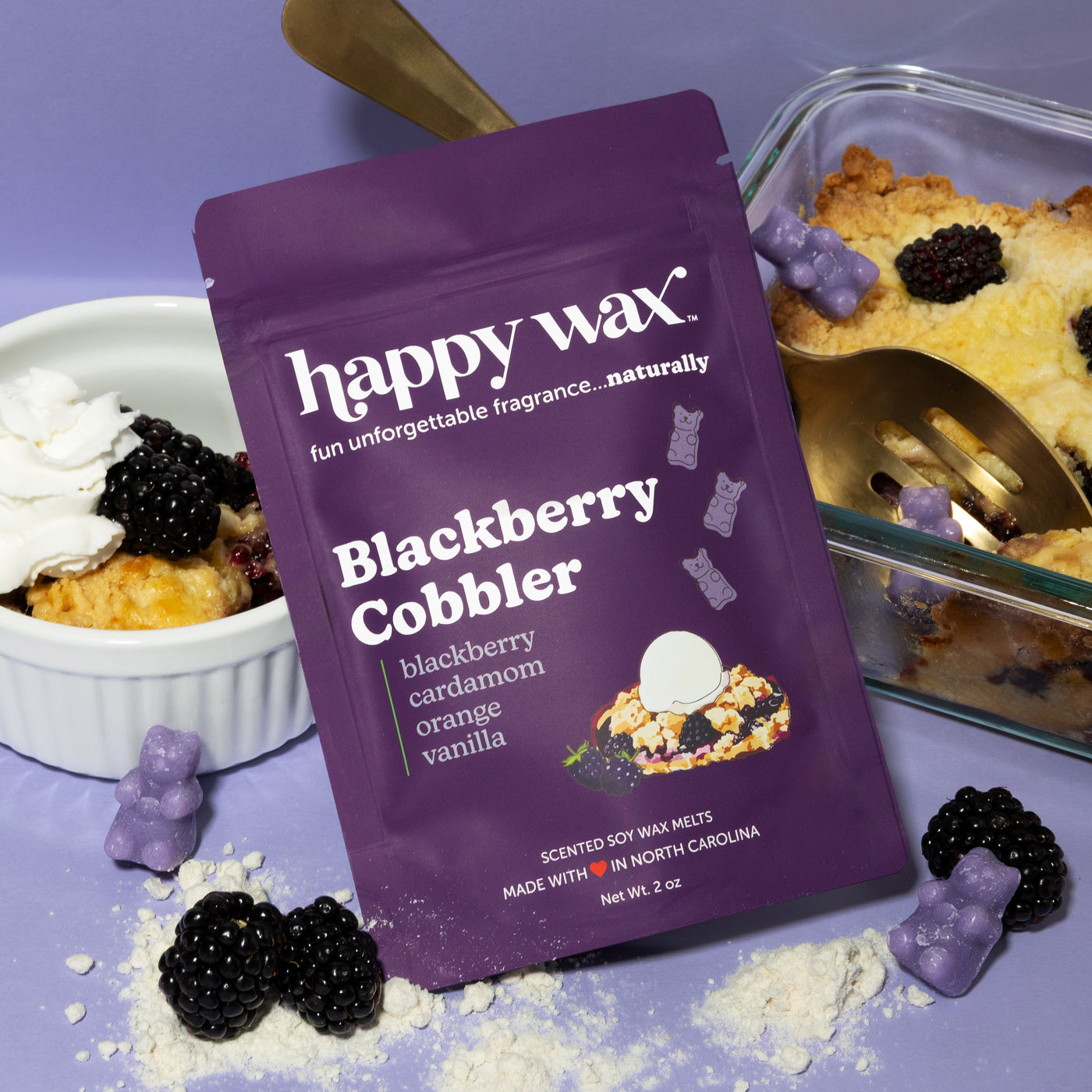 Happy Wax Blackberry Cobbler Pouch with blackberries, cobbler, and powdered sugar on a light violet background