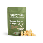 Green pouch of Happy Wax brand Brown Butter & Sage wax melts with cream-colored wax chunks displayed in front.