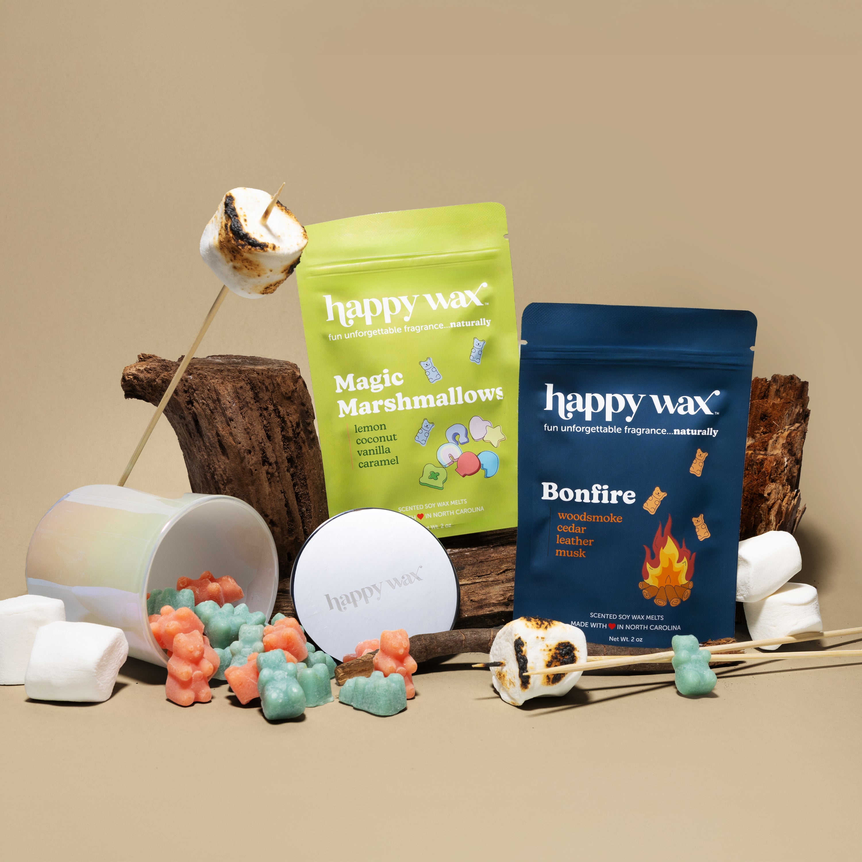 Happy Wax melts pouches and iridescent jar on beige background with toasted marshmallows and wood
