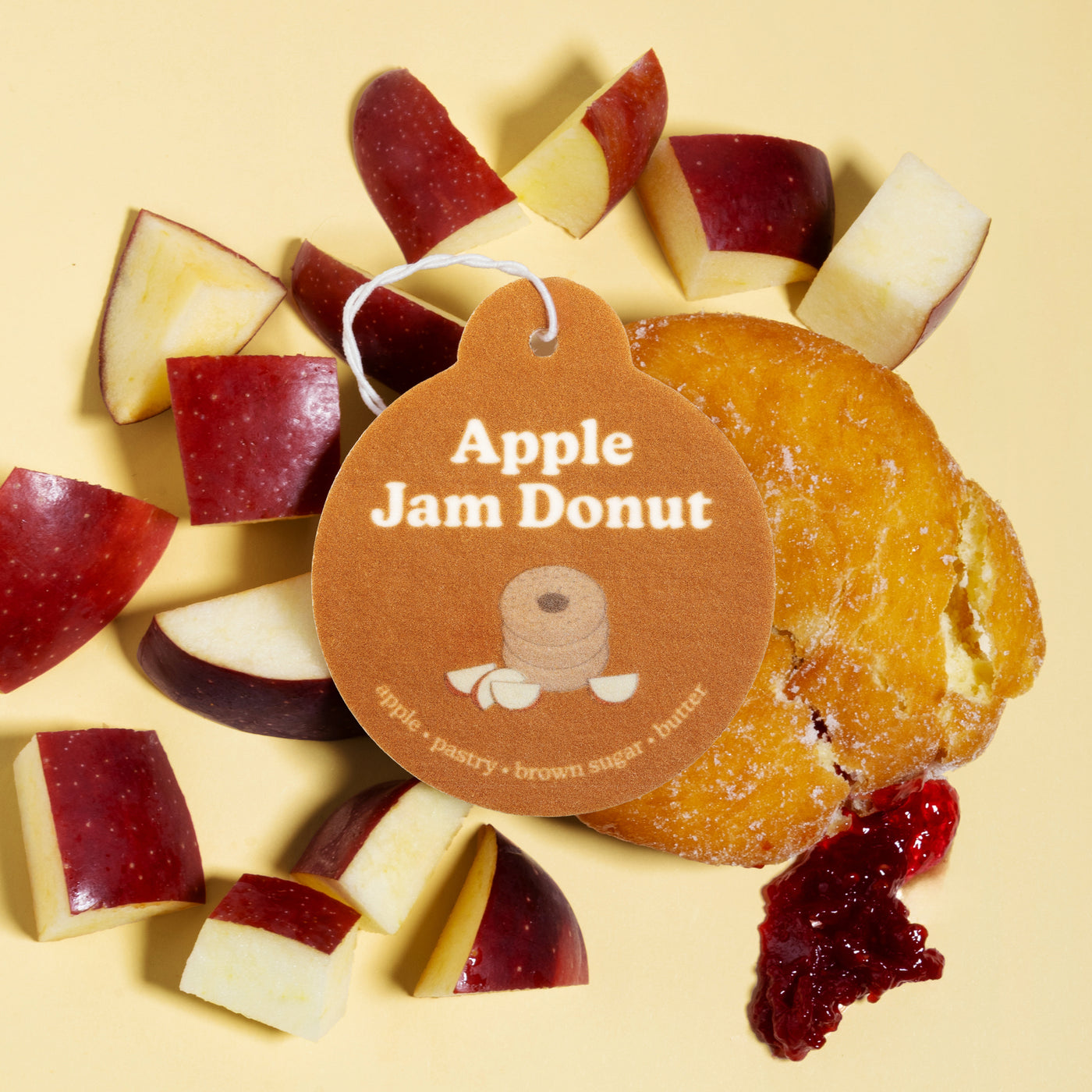 Happy Wax Apple Jam Donut Car Charm with apples and Apple Jam donut on pale yellow background
