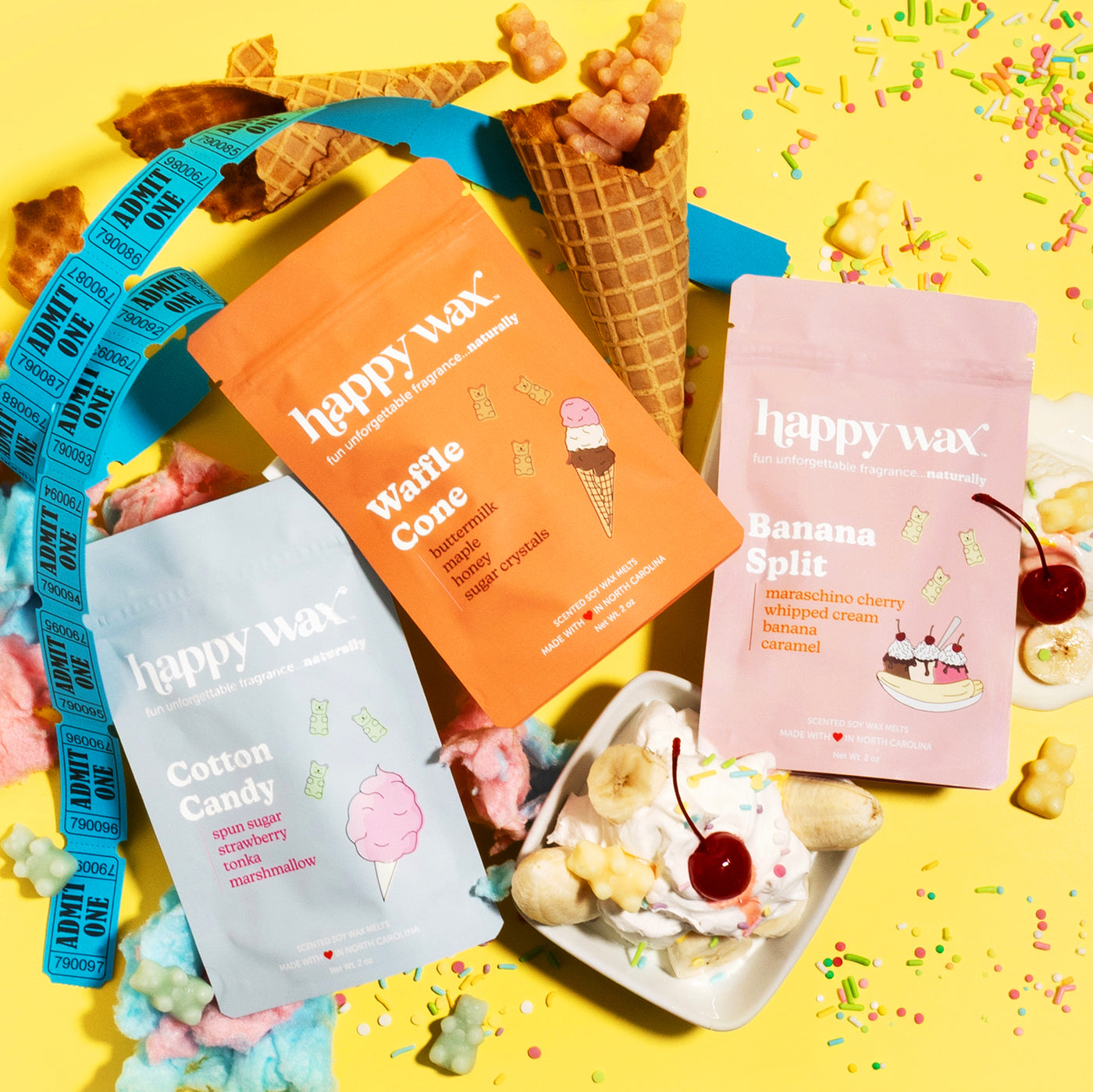 Happy Wax Carnival Collection wax melts packaging with carnival designs, ice cream, cotton candy and sprinkles on a yellow background