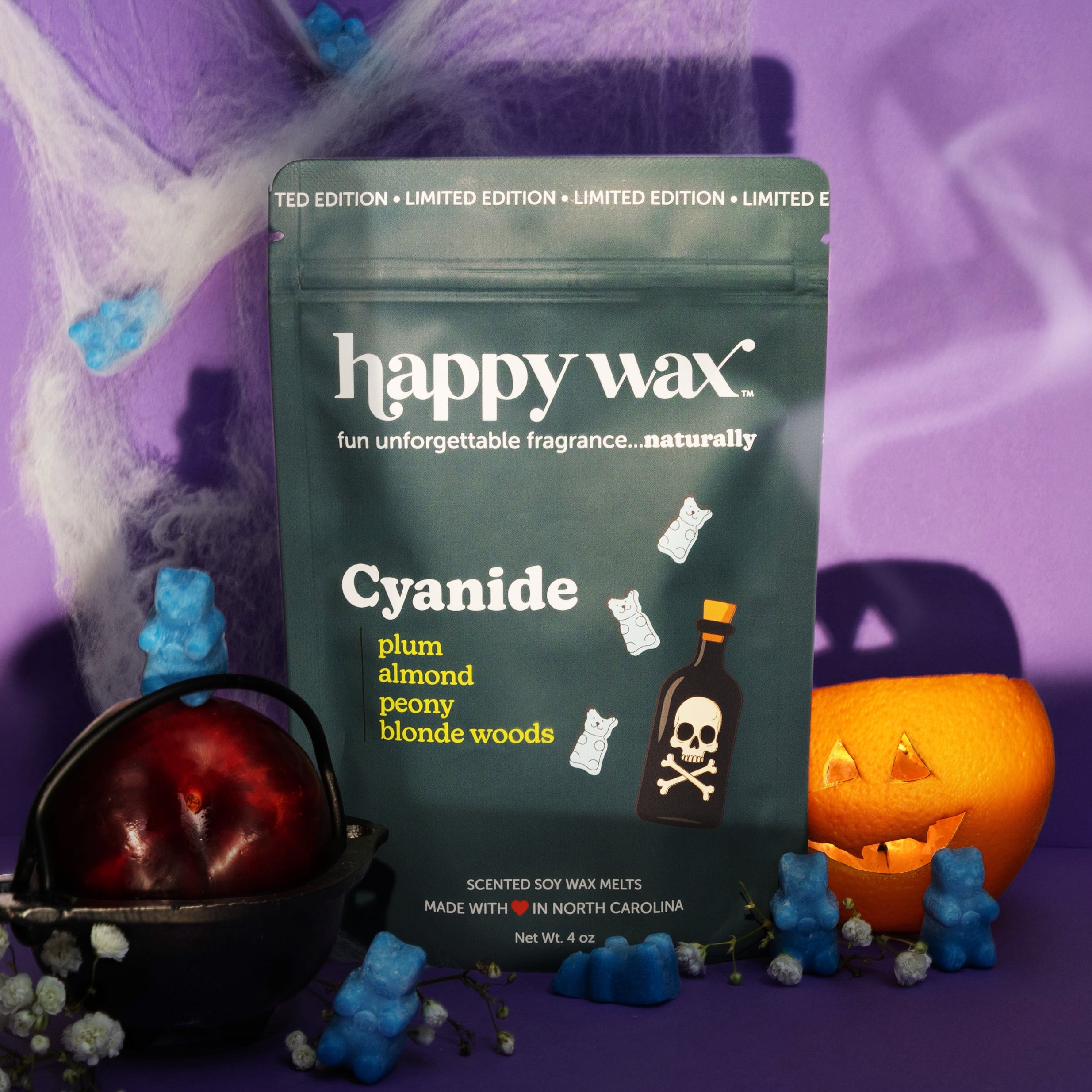 Happy Wax Cyanide Pouch with cauldrin, plum, jack o lantern, spider webs blue wax bears and heavy shadows on purple background