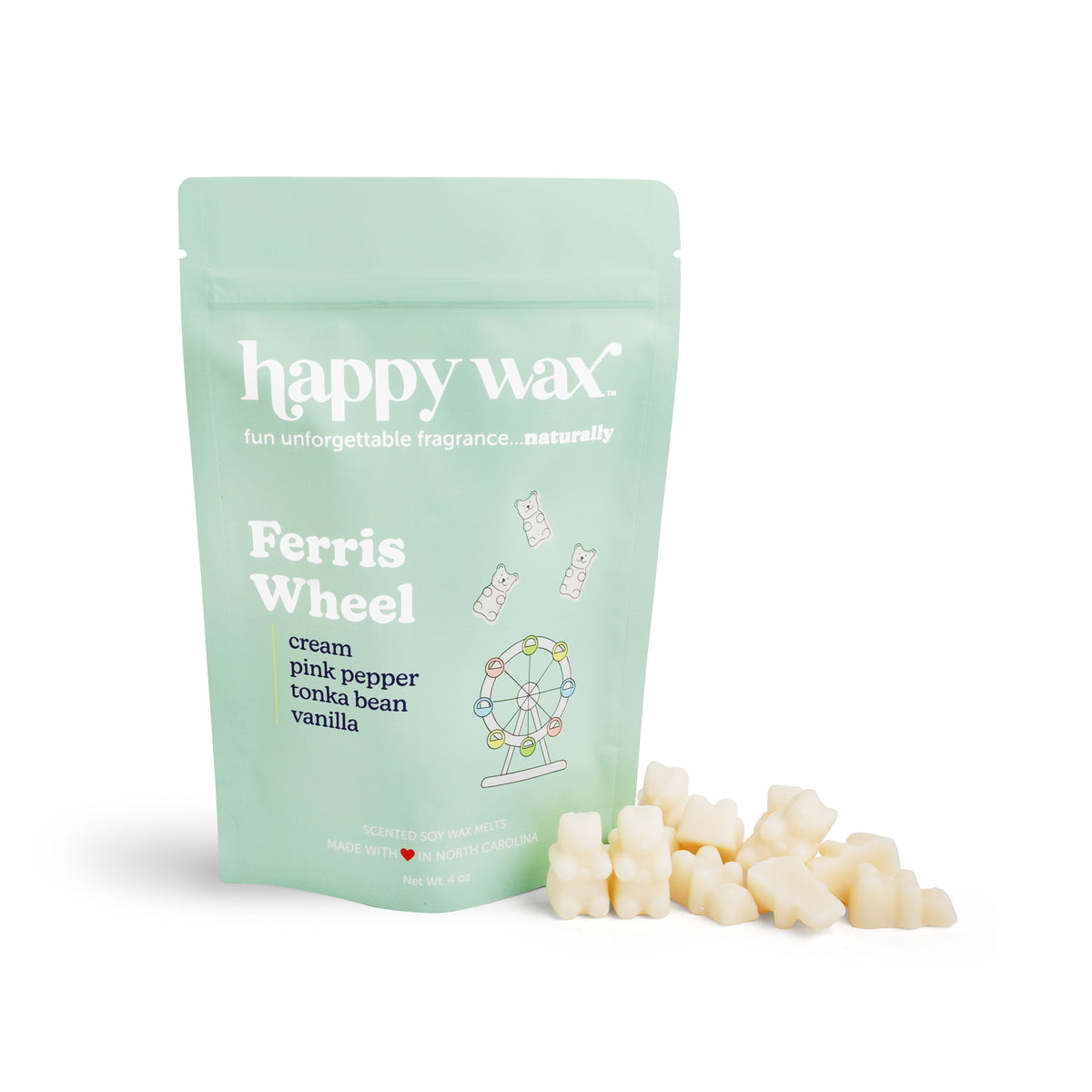 Mint green pouch of happy wax Ferris Wheel wax melts with cream-colored wax pieces displayed in front.