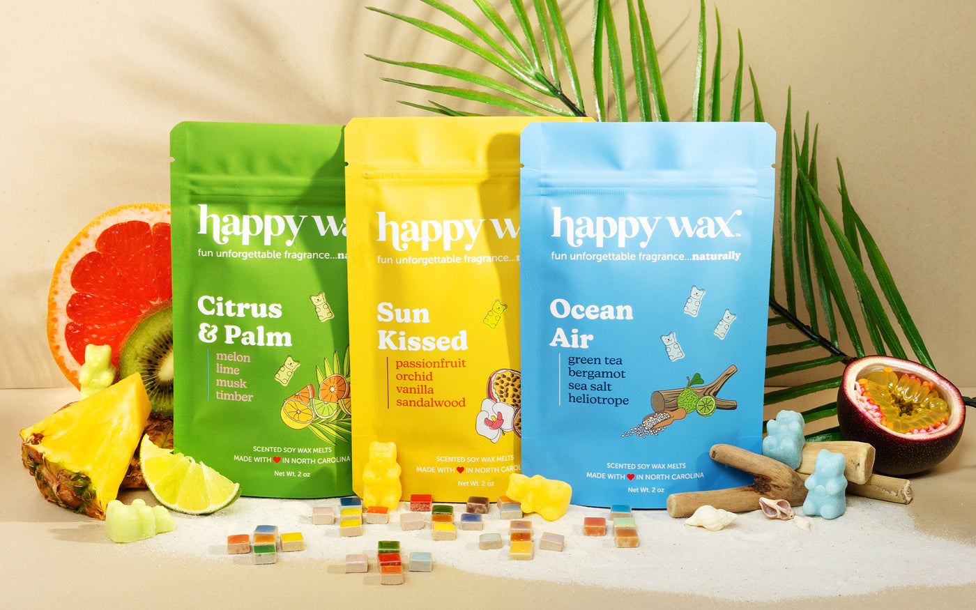 Wax melt pouches on tan background with fruit and palm frond