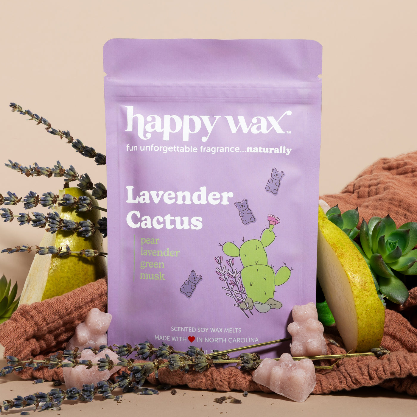 Happy Wax Lavender Cactus pouch with lavender, pears, succulents and rust colored linens on sand colored background