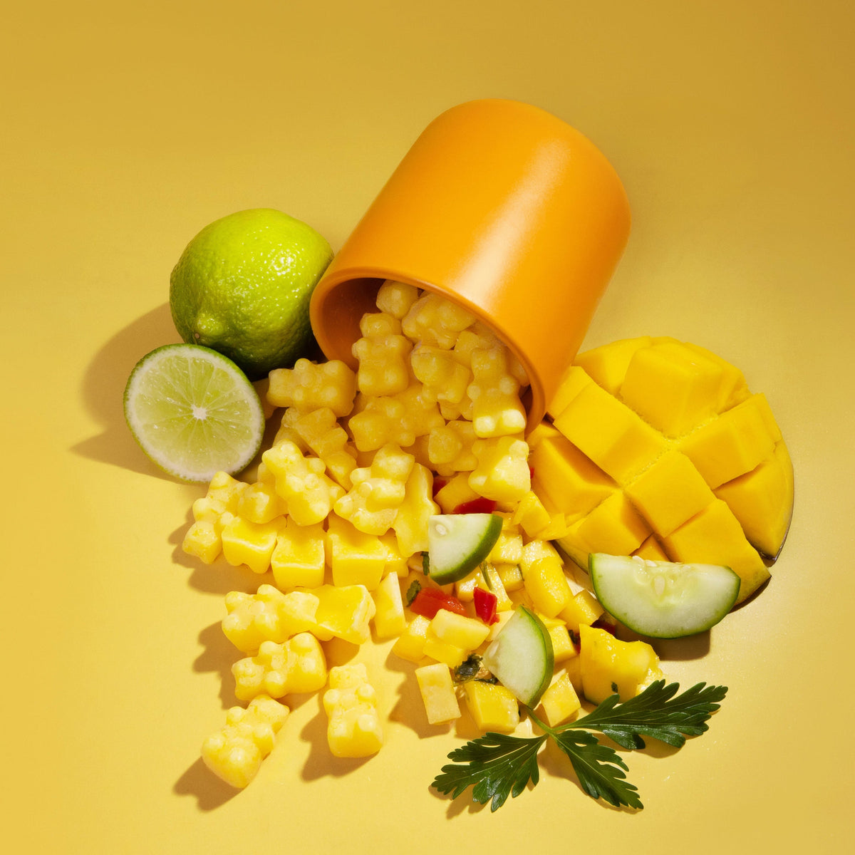 Mango, Limes, and Mango Salsa, wax melts and orange container spilling onto yellow background.