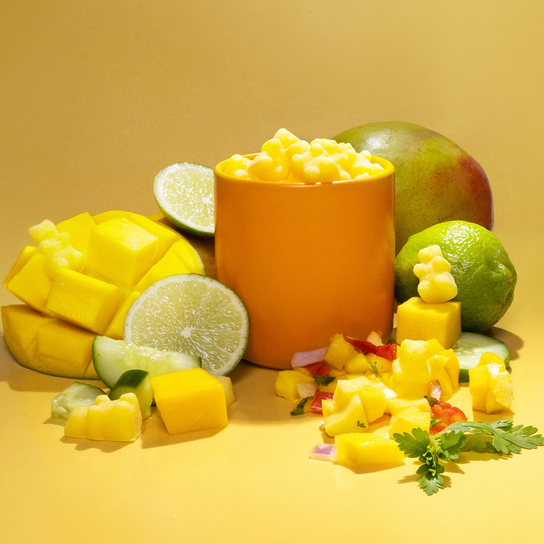 Mango Salsa scented wax melts on yellow background with mangos and limes