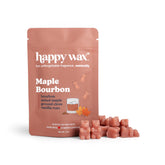 Rose-colored wax melt cubes next to a happy wax brand pouch labeled Maple Bourbon with ingredient list and maple leaf illustr