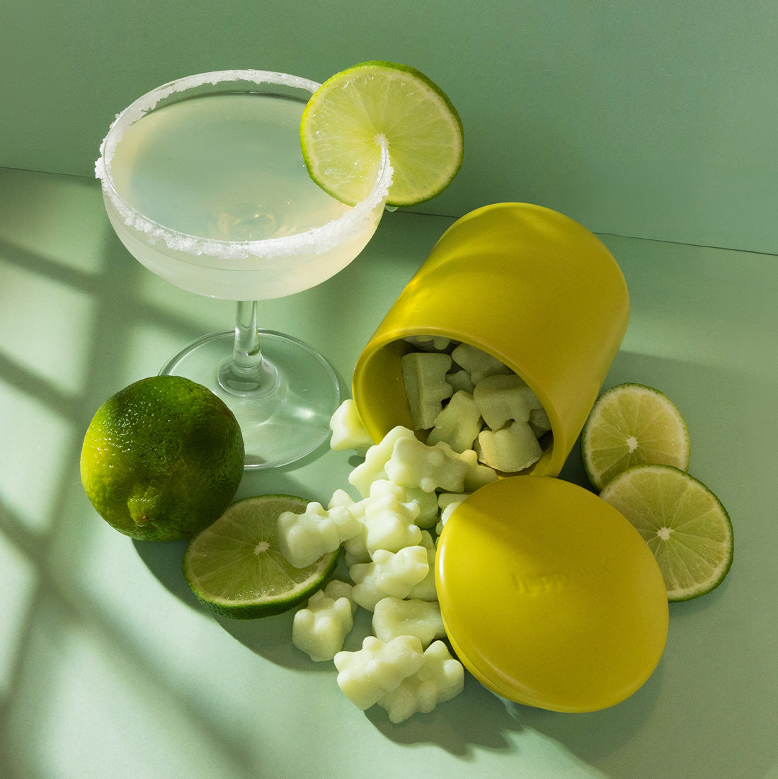 Margarita scented wax melts on green background with limes