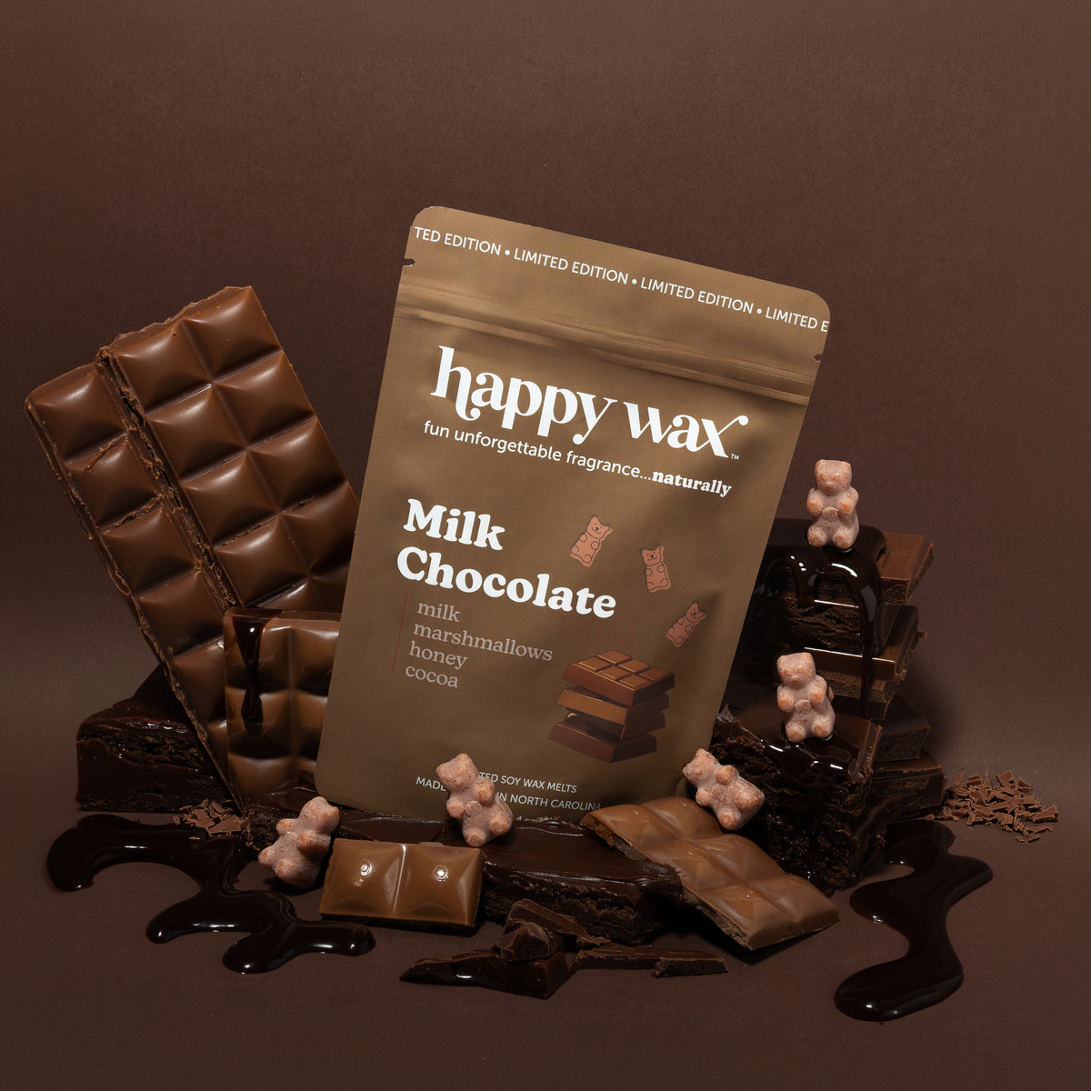 Happy Wax Milk Chocolate Pouch with brown wax bears, chocolate bar, chocolate sauce and chocolate cake on brown background