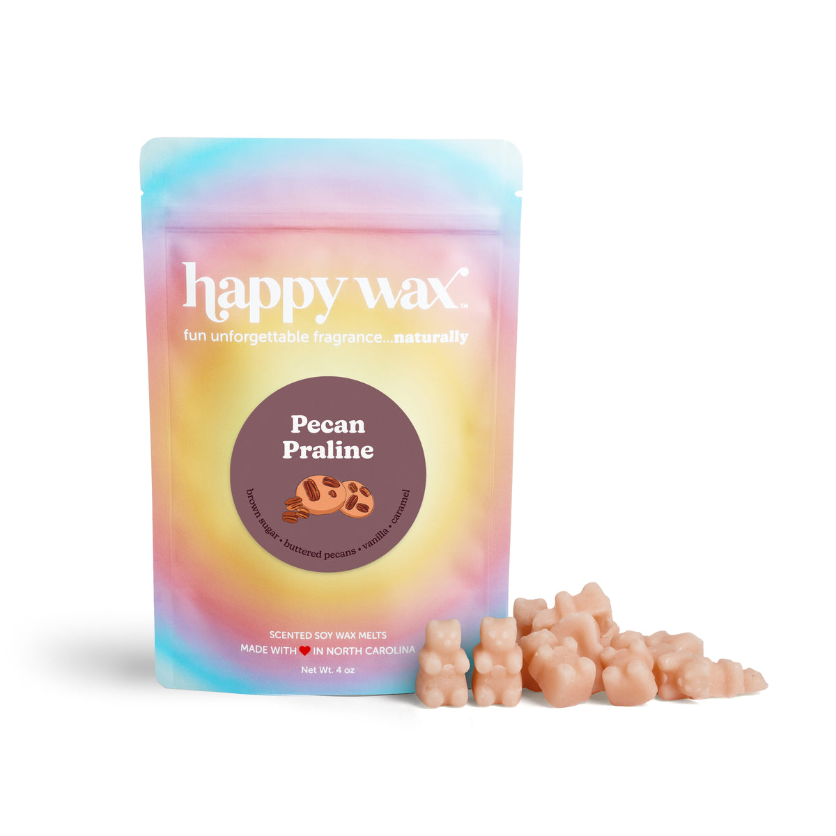 Peach-colored wax melts next to a gradient pastel pouch labeled "Pecan Praline" by Happy Wax.
