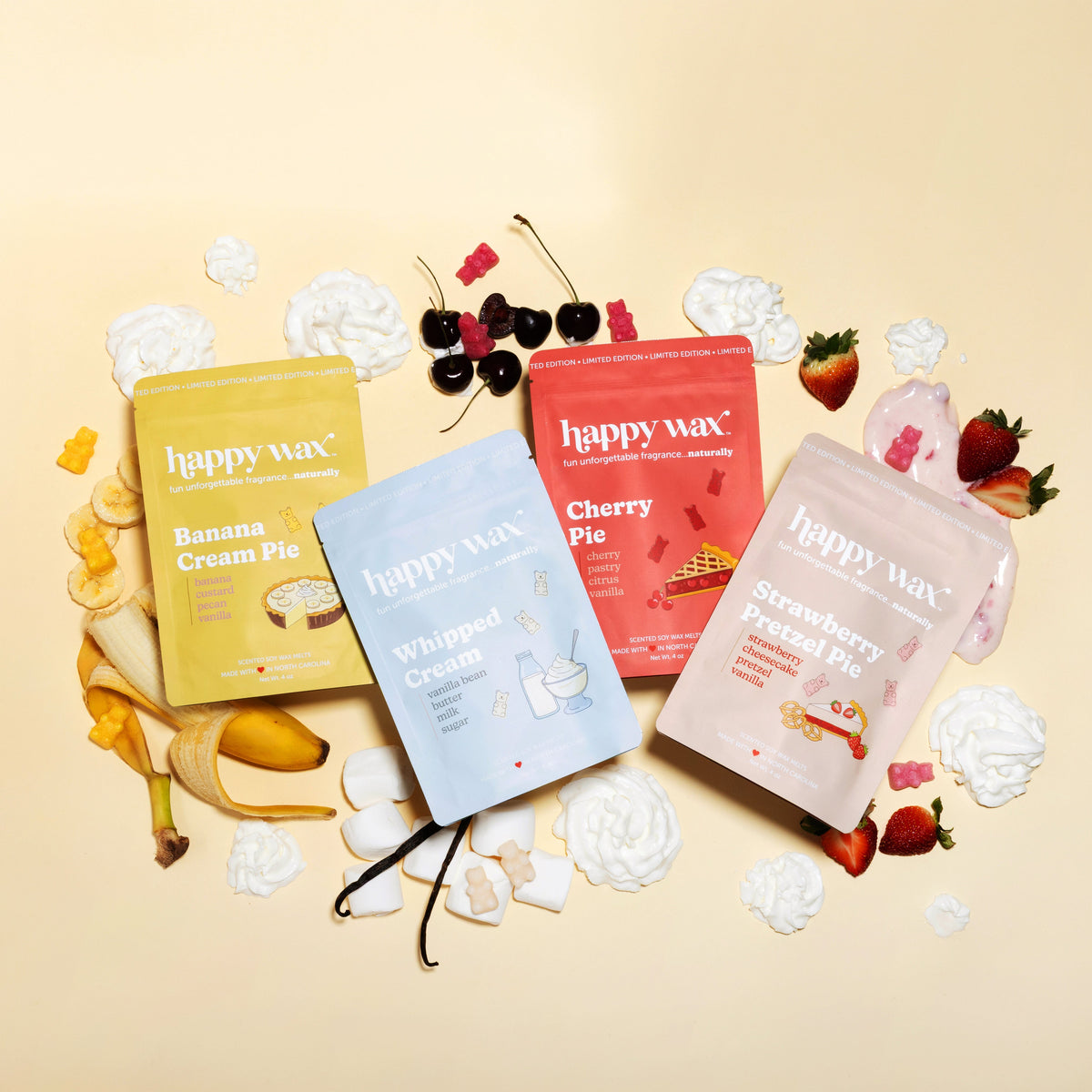 Happy Wax wax melts with fruit and dessert-themed packaging on a beige background