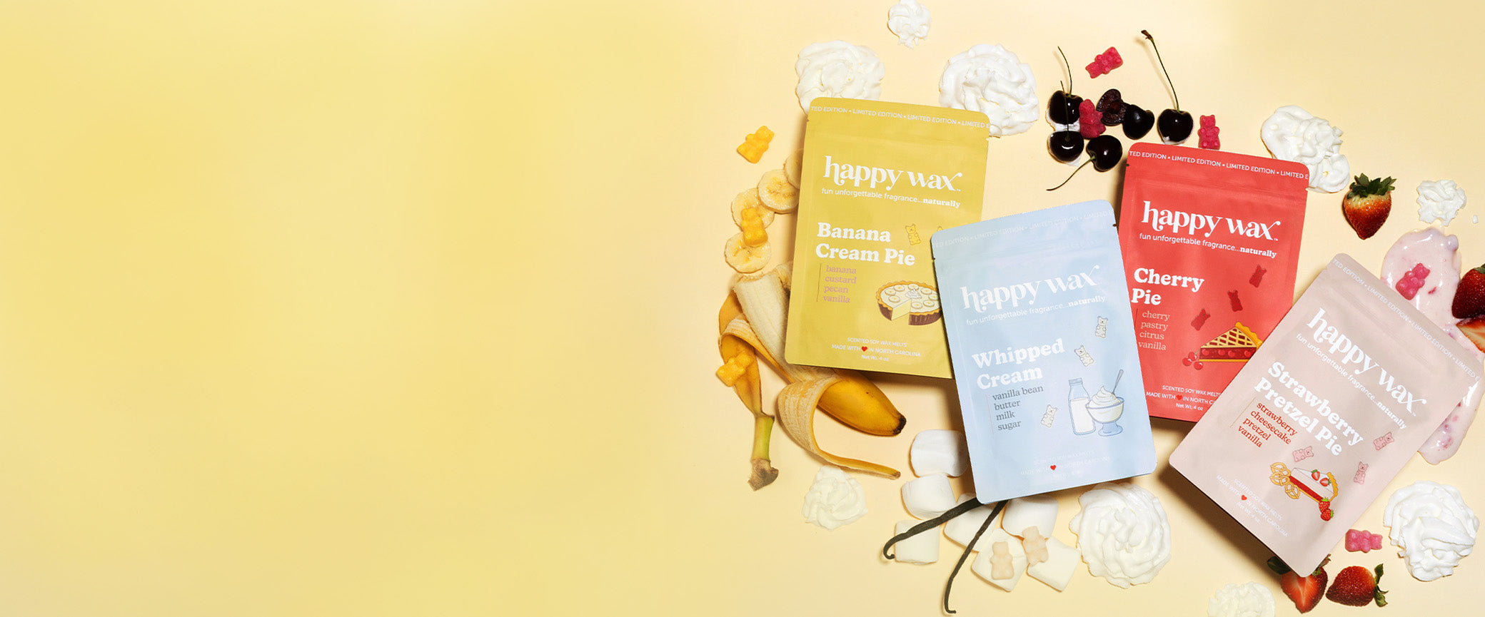 Happy Wax Pie Shop wax melt collection pouches on yellow background with fruit and whipped cream