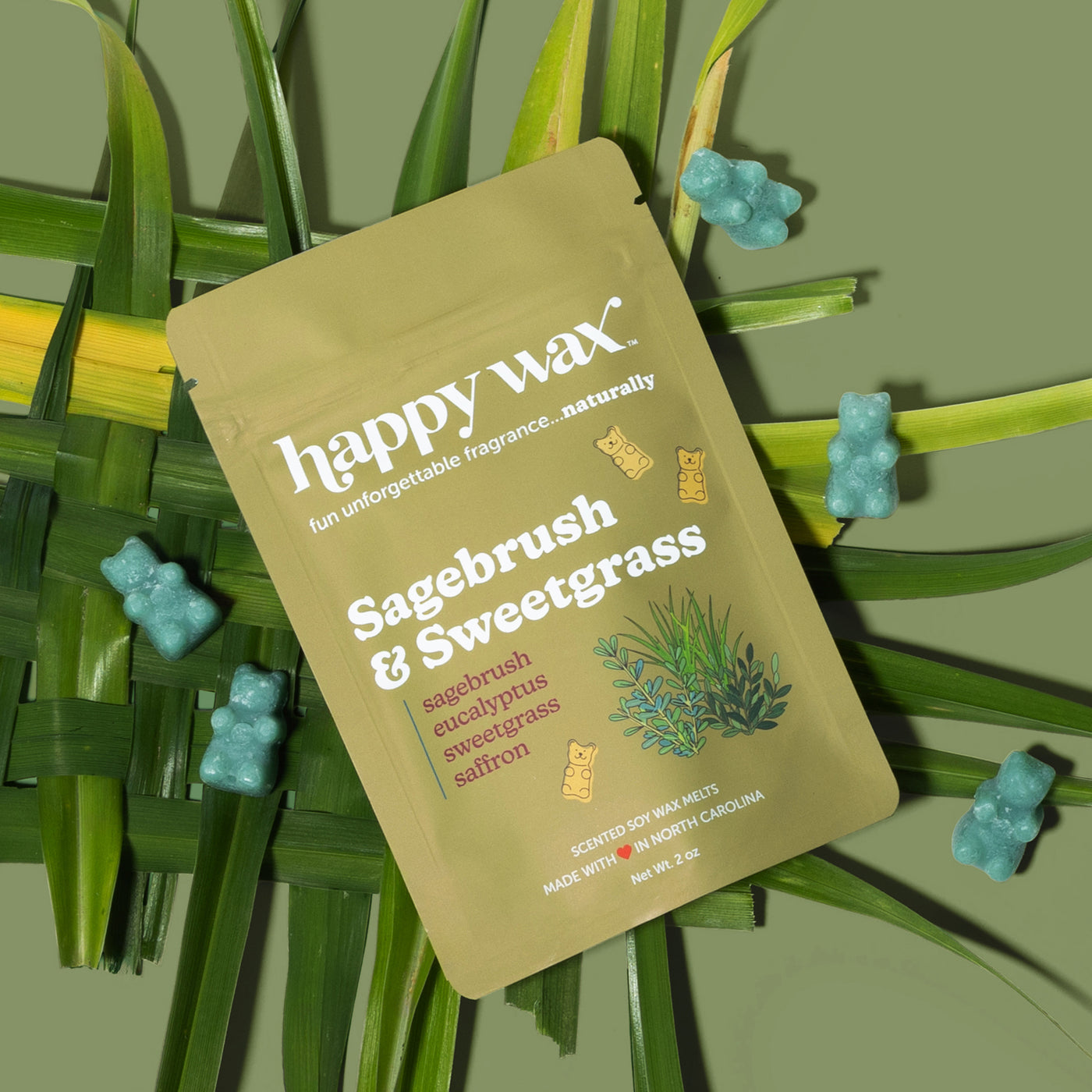 Happy Wax Sagebrush & Sweetgrass pouch with greenery and green wax bears on light green background