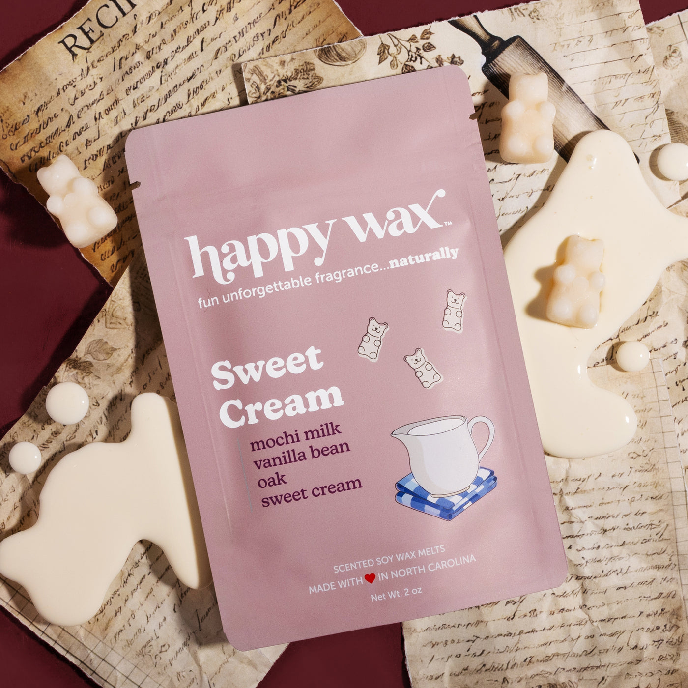 Happy Wax Sweet Cream pouch on old recipes and spilt sweet cream on a dark red background