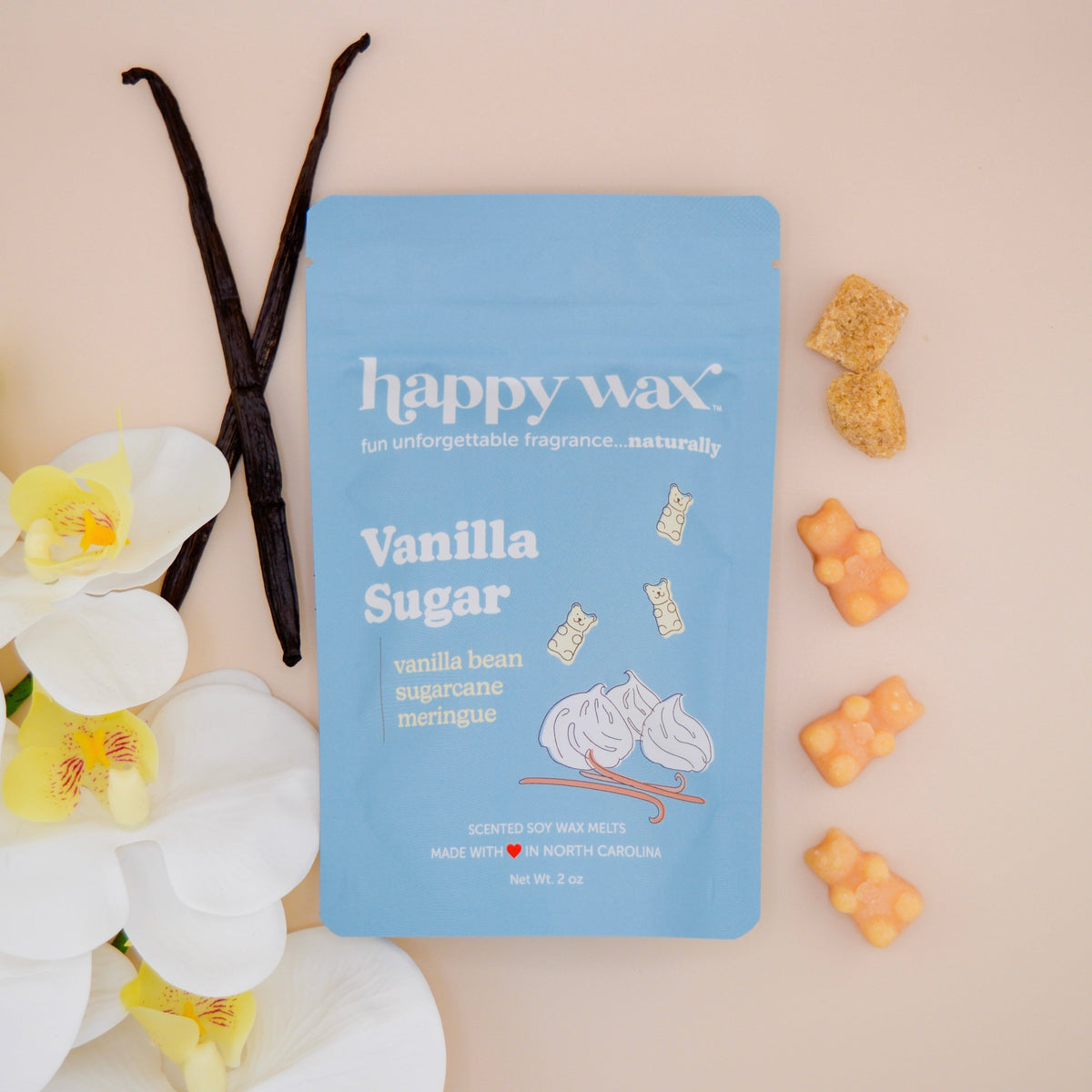 Vanilla Sugar wax melt pouch on tan background with white flowers and vanilla beans