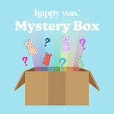 Open cardboard box displaying colorful gummy bear wax products with question marks on light blue background.